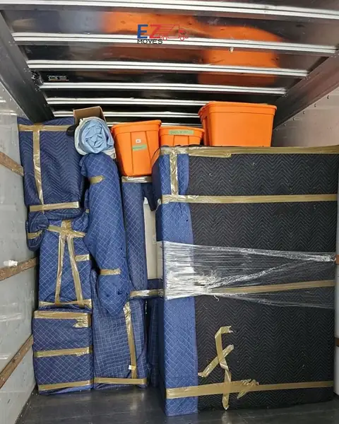 Blanket-wrapped furniture loaded inside a moving truck