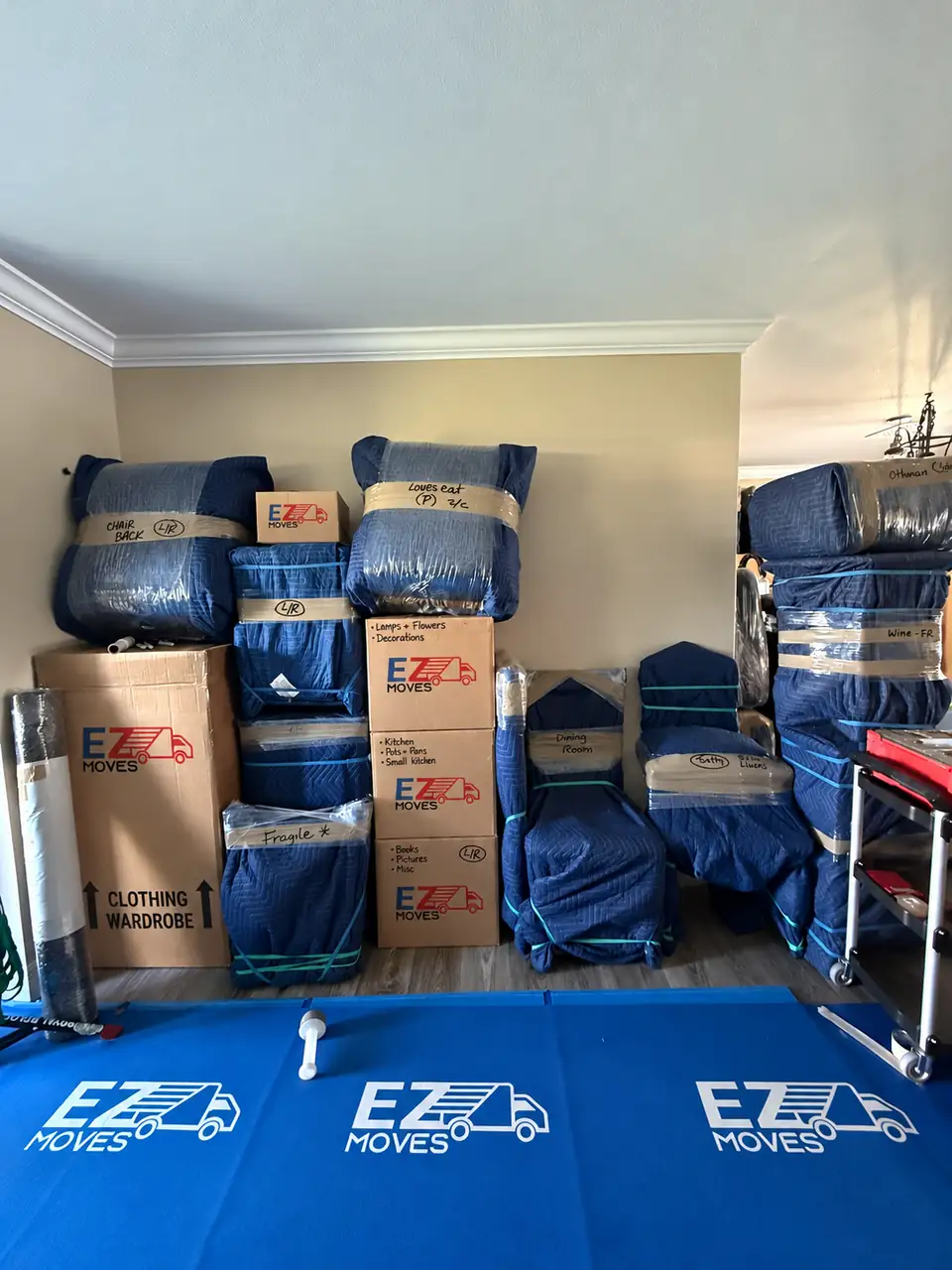 Packed furniture and boxes with EZ MOVES branding